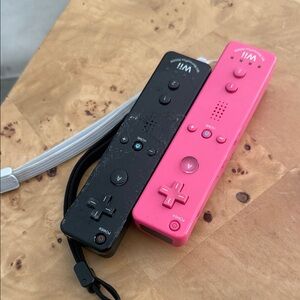 Nintendo Wii Remote Controllers in Pink and Black
